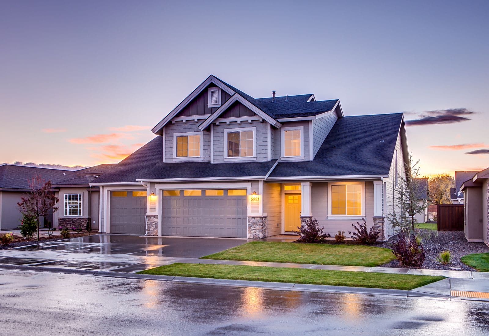 Suburban family home lit at dusk
